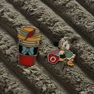 Disney coffee cup and Disney duck pin